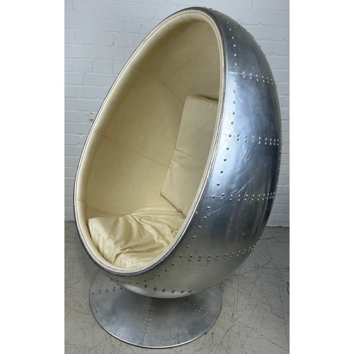 468A - IN THE MANNER OF EERO AARNIO: A SWIVEL AVIATOR EGG CHAIR, 

Chromed metal with beige leather interio... 