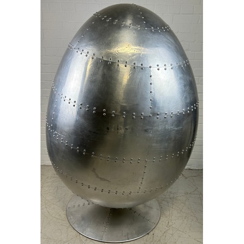 468A - IN THE MANNER OF EERO AARNIO: A SWIVEL AVIATOR EGG CHAIR, 

Chromed metal with beige leather interio... 