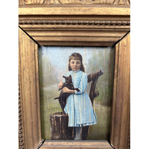 18 - DOG INTEREST: AN OIL PAINTING POSSIBLY OVER A PHOTOGRAPH ON BOARD DEPICTING A GIRL IN A BLUE DRESS H... 