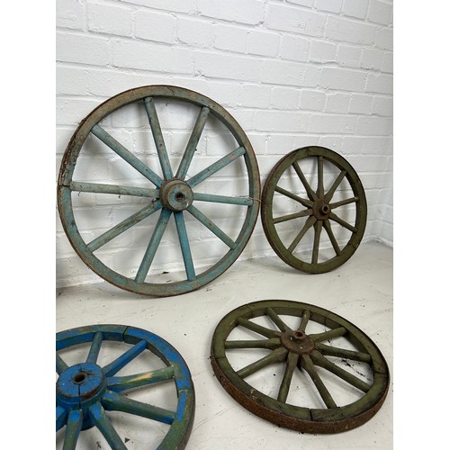 68 - A GROUP OF SEVEN ANTIQUE PAINTED CARTWHEELS, 

Largest 60cm D