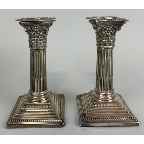 144 - A PAIR OF SILVER CORINTHIUM CANDLESTICKS, 

16cm H

Weighted. 

Total weight: 860gms