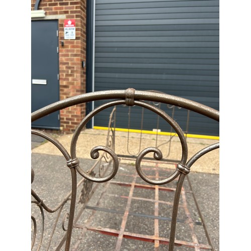 125 - A LARGE WROUGHT IRON BED WITH SCROLLING ENDS AND CREST,

180cm x 105cm x 80cm