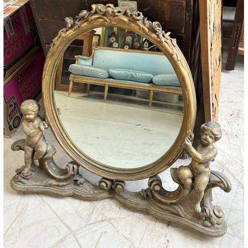 101 - A FRENCH GILDED WALL MIRROR FLANKED BY PUTTI, 

90cm x 80cm