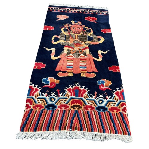 897 - A LARGE CHINESE OR TIBETAN CARPET DEPICTING A WARRIOR, 

250cm x 125cm