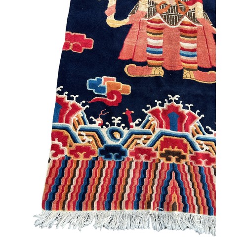 897 - A LARGE CHINESE OR TIBETAN CARPET DEPICTING A WARRIOR, 

250cm x 125cm