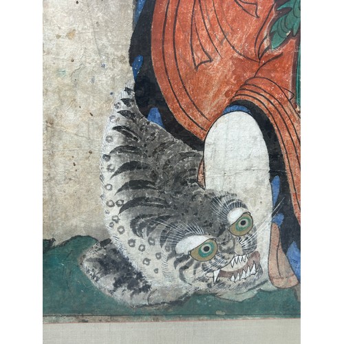 106 - A KOREAN PAINTING DEPICTING SANSHIN AND TIGER,

83cm x 71cm 

Mounted in a frame and glazed. 

107cm... 