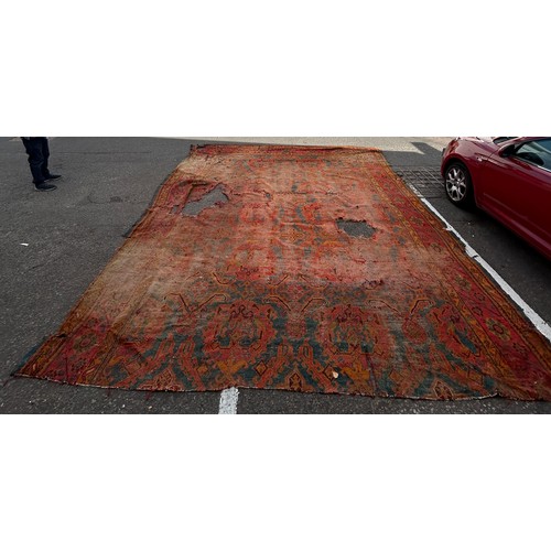 880 - A VERY LARGE ANTIQUE BLUE GROUND OUSHAK CARPET, 

Now fragmentary, and badly damaged. 

490cm x 390c... 