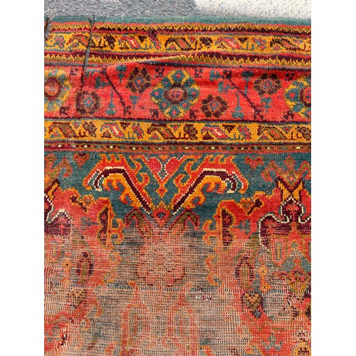 880 - A VERY LARGE ANTIQUE BLUE GROUND OUSHAK CARPET, 

Now fragmentary, and badly damaged. 

490cm x 390c... 