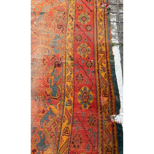 880 - A VERY LARGE ANTIQUE BLUE GROUND OUSHAK CARPET, 

Now fragmentary, and badly damaged. 

490cm x 390c... 