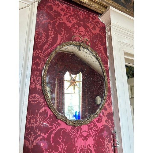 12 - AFTER A.M.E FOUNRIER: A PAIR OF FRENCH 19TH CENTURY ROPE TWIST OVAL WALL MIRROR, 

Gilt wood 51cm x ... 