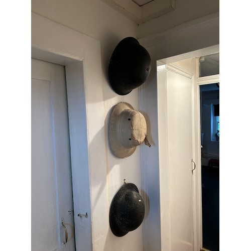 64 - A SET OF THREE MILITARY HELMETS, 

Largest 33cm x 25cm