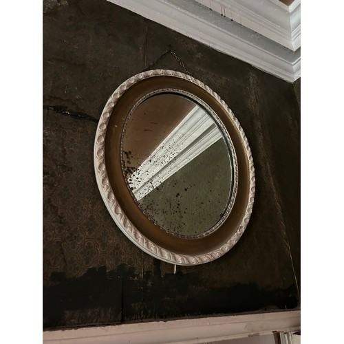 89 - A PAIR OF ANTIQUE OVAL WHITE PAINTED AND GILT WALL MIRRORS, 

64cm x 50cm