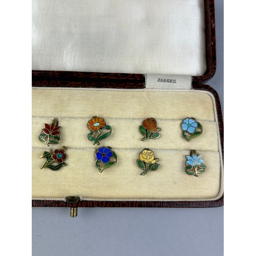 128 - A CASED SET OF FLORAL SILVER GILT AND ENAMEL LAPEL PINS MADE IN ENGLAND, 

Case marked 'Zarger'.