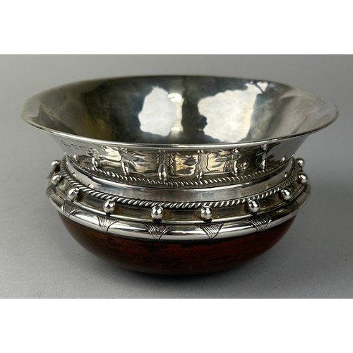 131 - ALBERT EDWARD JONES (BRITISH 1878-1954): A SILVER AND TURNED WOOD ARTS AND CRAFTS CUP, 

14cm x 7cm