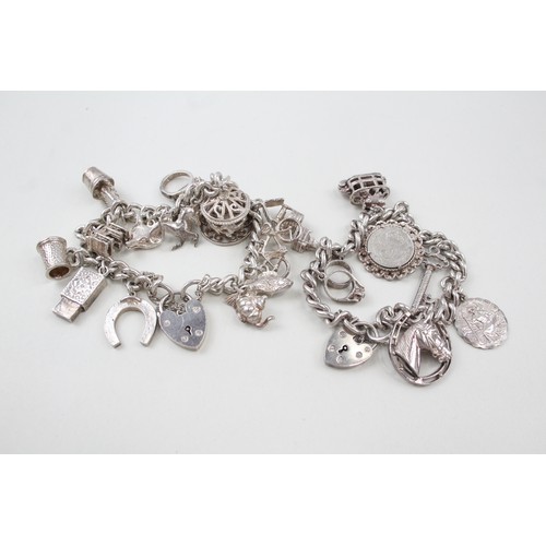 183 - TWO SILVER CHARM BRACELETS INCLUDING ANIMAL CHARMS, 

Weight: 107gms