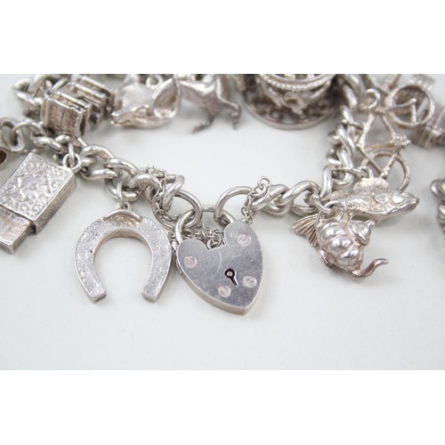 183 - TWO SILVER CHARM BRACELETS INCLUDING ANIMAL CHARMS, 

Weight: 107gms