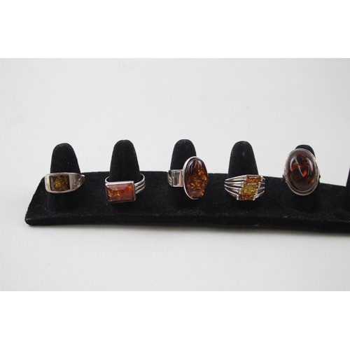 200 - A COLLECTION OF SILVER AND AMBER RINGS INCLUDING MODERNIST,

Weight: 27gms