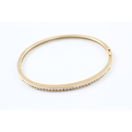 226 - AN 18CT GOLD CHANNEL SET ROUND BRILLIANT DIAMOND SET BANGLE,

Weight: 18.7gms