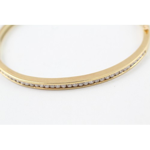 226 - AN 18CT GOLD CHANNEL SET ROUND BRILLIANT DIAMOND SET BANGLE,

Weight: 18.7gms