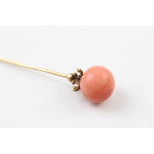 236 - AN 18CT GOLD ANTIQUE CORAL BEAD SET HAIRPIN,

Weight: 5.4gms