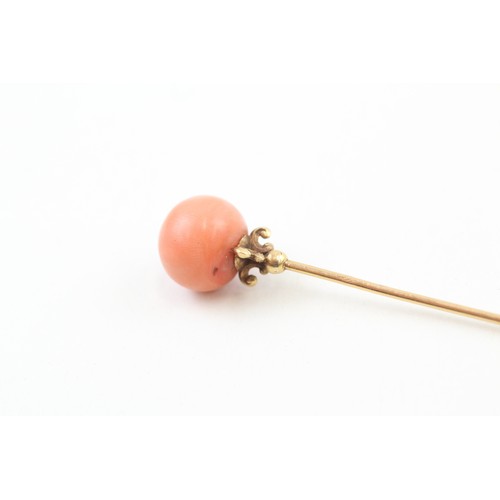 236 - AN 18CT GOLD ANTIQUE CORAL BEAD SET HAIRPIN,

Weight: 5.4gms