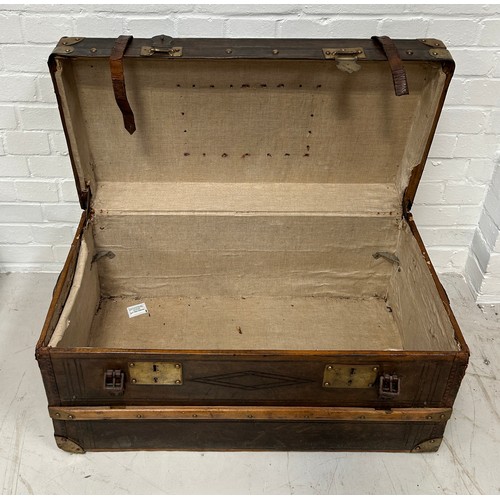 757 - A LEATHER AND BRASS BOUND TRAVEL TRUNK, 

80cm x 43cm x 41cm