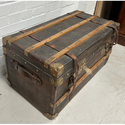 757 - A LEATHER AND BRASS BOUND TRAVEL TRUNK, 

80cm x 43cm x 41cm