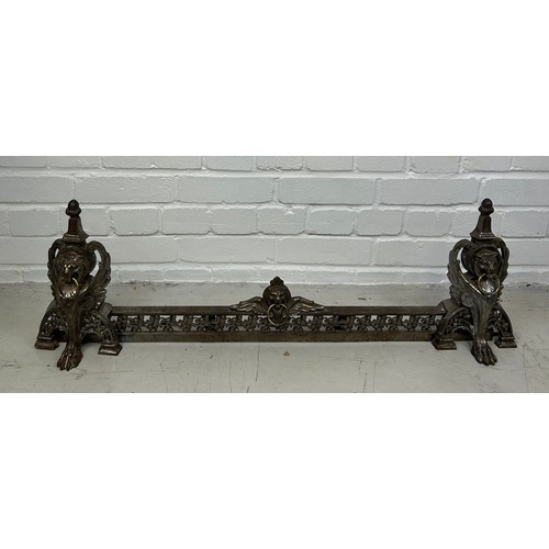 779 - AN ANTIQUE METAL FIRE FENDER DECORATED WITH WINGED LIONS HEAD MASKS AND PAW FEET, 

98cm x 31cm