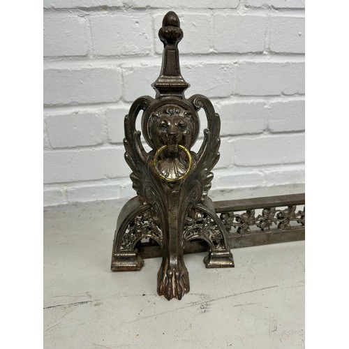 779 - AN ANTIQUE METAL FIRE FENDER DECORATED WITH WINGED LIONS HEAD MASKS AND PAW FEET, 

98cm x 31cm