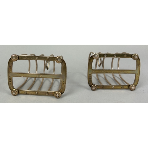 12 - A PAIR OF SILVER TOAST RACKS MARKED FOR HARRODS ALONG WITH A SUGAR SHAKER (3) Total weight: 308gms