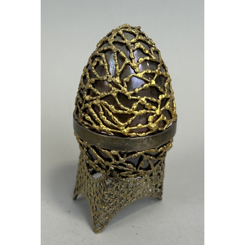 9 - A STUART DEVLIN SILVER SURPRISE EGG AND STAND, OPENING TO REVEAL AN AMETHYST CRYSTAL 9.5cm H with st... 