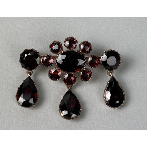 5 - A VICTORIAN GARNET BROOCH CIRCA 1890'S Cluster design supporting three drops set with pear-shaped an... 