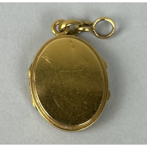 3 - AN ANTIQUE OVAL GOLD LOCKET WITH HALF-PEARL SET CROSS TO CENTRE 1.5cm high, together with a gold tra... 