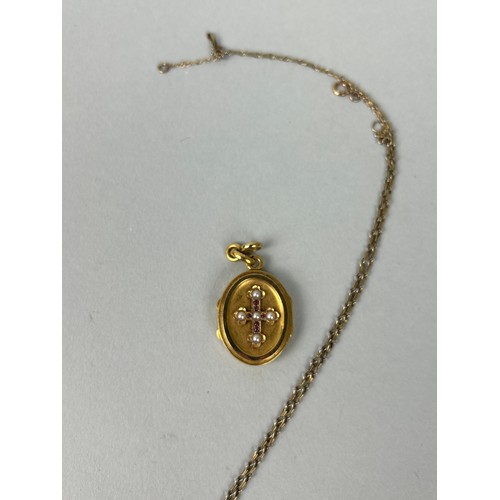 3 - AN ANTIQUE OVAL GOLD LOCKET WITH HALF-PEARL SET CROSS TO CENTRE 1.5cm high, together with a gold tra... 