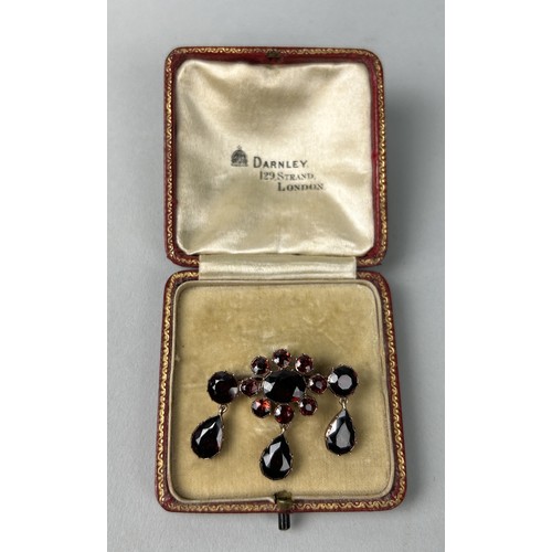 5 - A VICTORIAN GARNET BROOCH CIRCA 1890'S Cluster design supporting three drops set with pear-shaped an... 