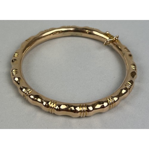 12 - AN 18CT GOLD FAUX BAMBOO BANGLE Weight: 36.2gms