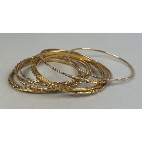 9 - A COLLECTION OF THIRTEEN CHINESE GOLD BANGLES MARKED 22CT OR 90% (13) Weight: 80gms