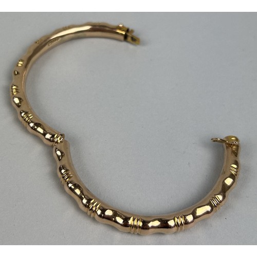 12 - AN 18CT GOLD FAUX BAMBOO BANGLE Weight: 36.2gms