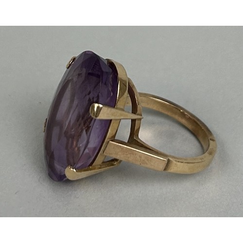 23 - A CHINESE GOLD RING SET WITH A LARGE AMETHYST 10.5gms