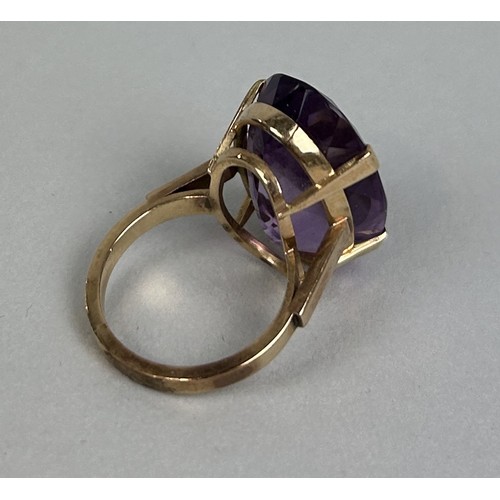 23 - A CHINESE GOLD RING SET WITH A LARGE AMETHYST 10.5gms