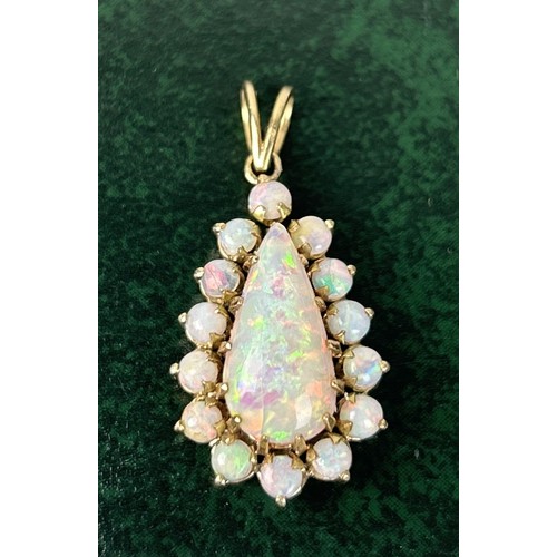 33 - AN 18CT GOLD PENDANT SET WITH A PEAR CUT OPAL SURROUNDED BY SMALL OPALS Weight: 5.4gms