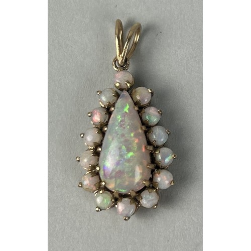 33 - AN 18CT GOLD PENDANT SET WITH A PEAR CUT OPAL SURROUNDED BY SMALL OPALS Weight: 5.4gms