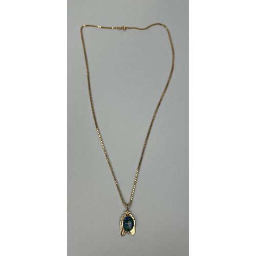 65 - A BLACK OPAL SET IN 9CT GOLD PENDANT WITH 9CT GOLD CHAIN Weight: 9 gms