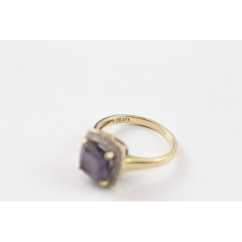 108 - A 9CT GOLD AMETHYST SINGLE STONE RING WITH DIAMOND SURROUND Weight: 3.5gms