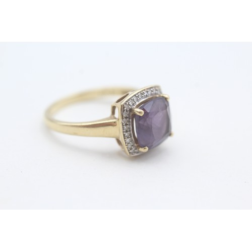 108 - A 9CT GOLD AMETHYST SINGLE STONE RING WITH DIAMOND SURROUND Weight: 3.5gms