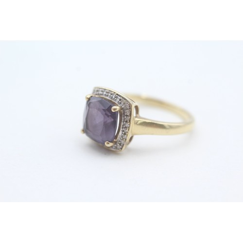 108 - A 9CT GOLD AMETHYST SINGLE STONE RING WITH DIAMOND SURROUND Weight: 3.5gms