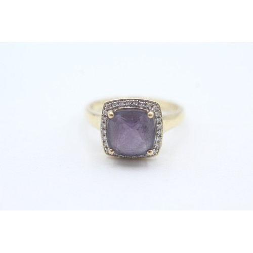 108 - A 9CT GOLD AMETHYST SINGLE STONE RING WITH DIAMOND SURROUND Weight: 3.5gms