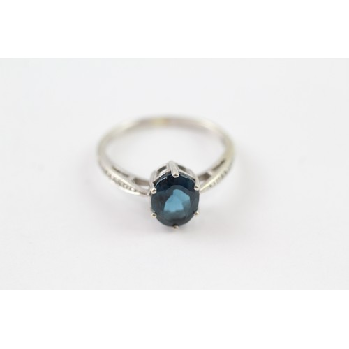 125 - A 9CT GOLD OVAL CUT BLUE TOPAZ AND DIAMOND DRESS RING Weight: 2.7gms