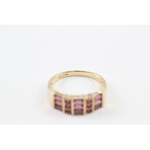 126 - A 9CT GOLD RUBY AND GARNET DRESS RING Weight: 3.2gms