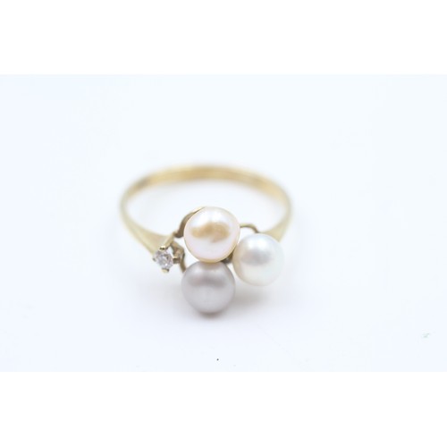 144 - A 9CT GOLD CULTURED PEARL AND CUBIC ZIRCONIA DRESS RING Weight: 2.2gms